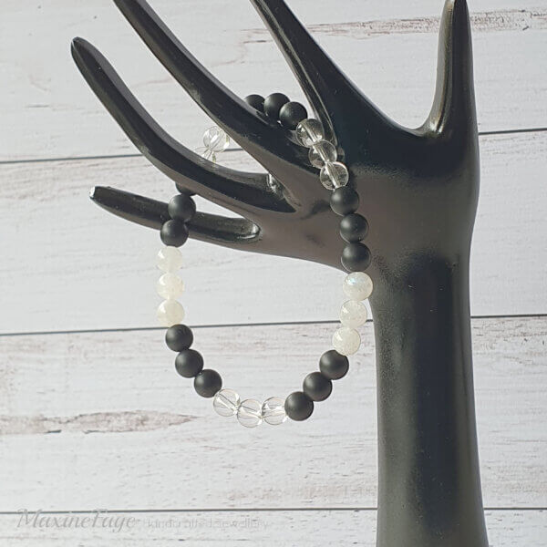 This Moonstone, Clear Quartz Crystal & Matte Black Onyx gemstone stretch bracelet is suitable for people who have a metal allergy.