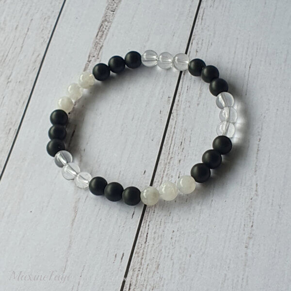 This Moonstone, Clear Quartz Crystal & Matte Black Onyx gemstone stretch bracelet is suitable for people who have a metal allergy.