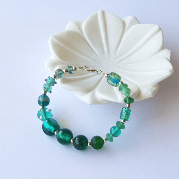 gorgeous lamp-work beads in shades of greens are the feature of this beautiful Teal Green glass bracelet