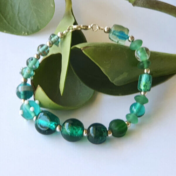 gorgeous lamp-work beads in shades of greens are the feature of this beautiful Teal Green glass bracelet